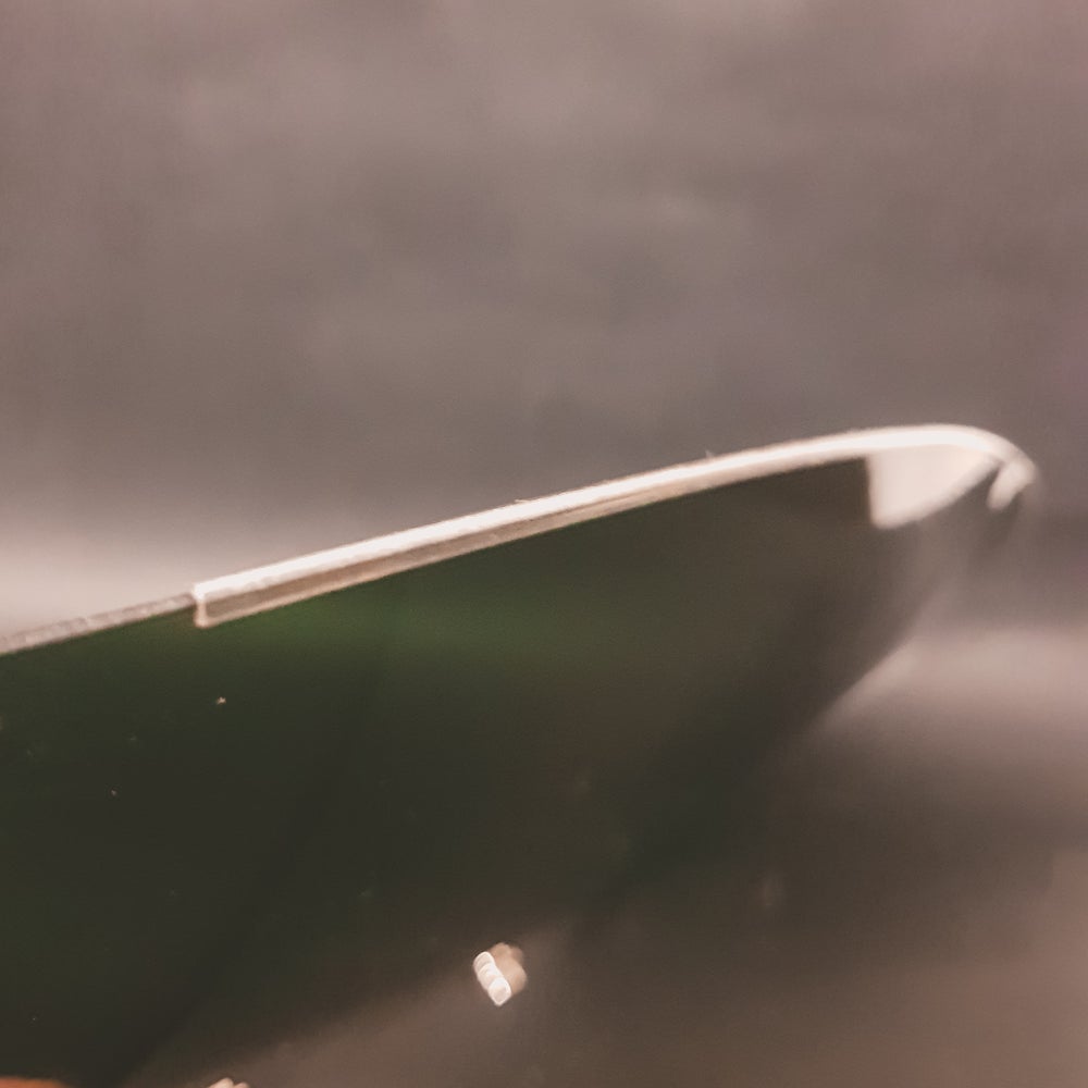Plastic bottom protection on the NOS 1960's flat motorcycle helmet shield