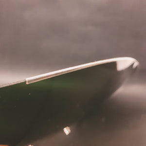 Plastic bottom protection on the NOS 1960's flat motorcycle helmet shield